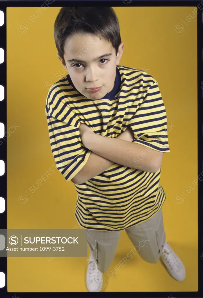 Portrait of a boy standing with his arms folded
