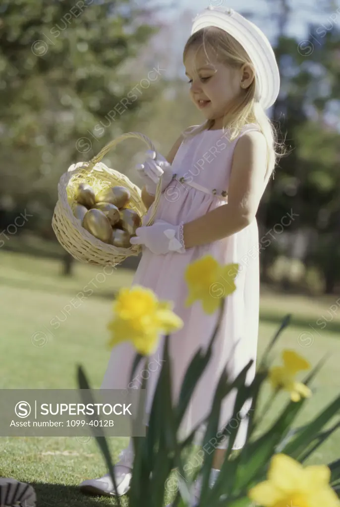 Side profile of a girl holding an Easter basket