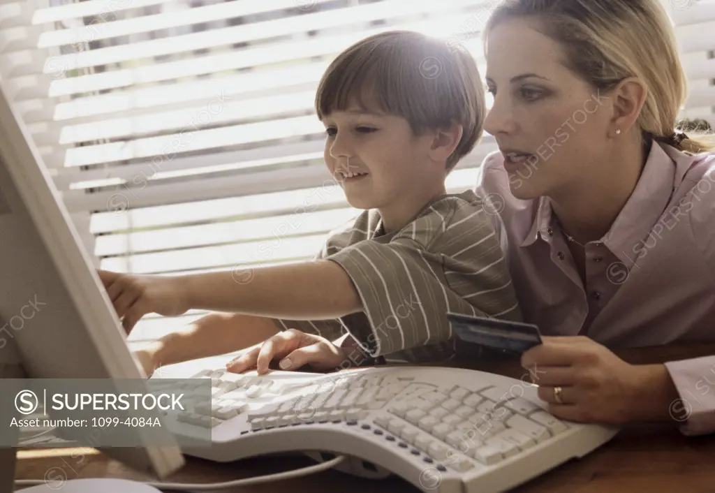 Mother and her son using a computer