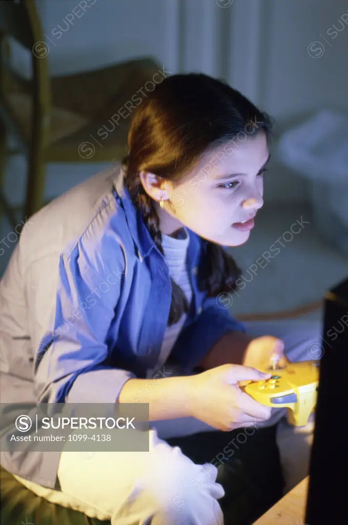 High angle view of a teenage girl playing video games
