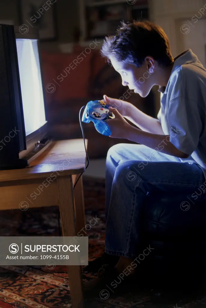 Side profile of a boy playing a video game