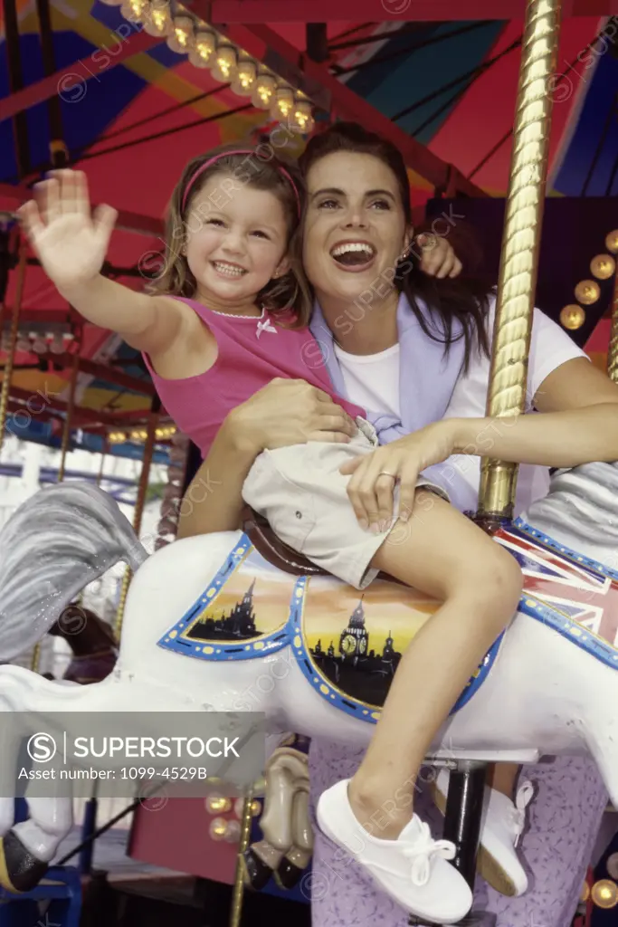 Mother and her daughter on a carousel