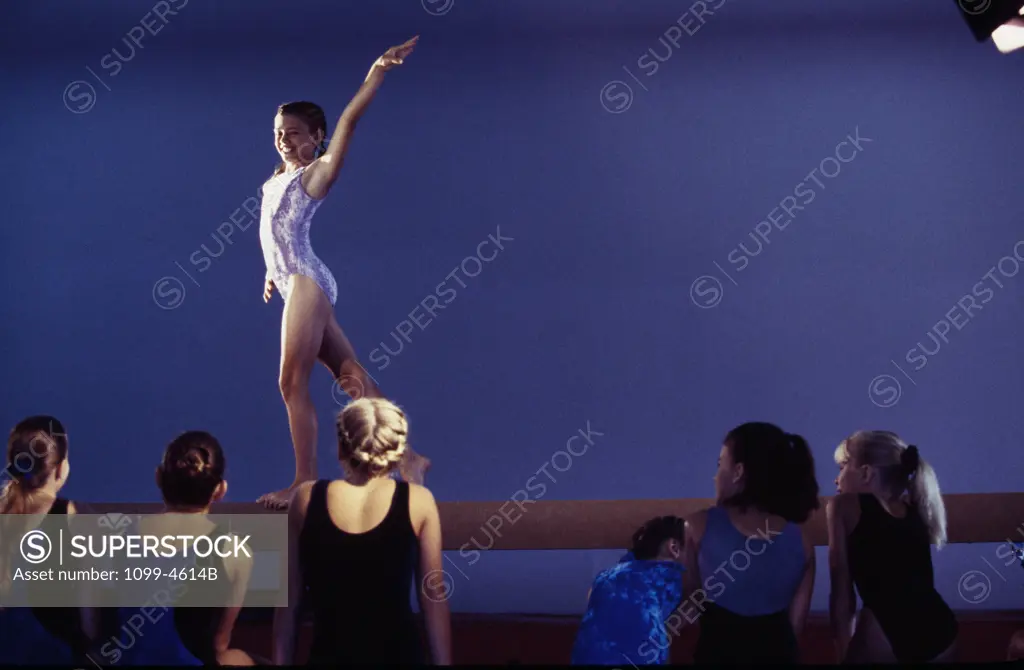 Female gymnast performing on a balance beam