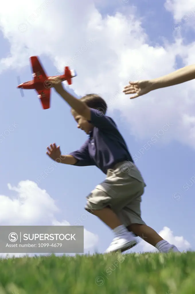 Boy playing with a model airplane