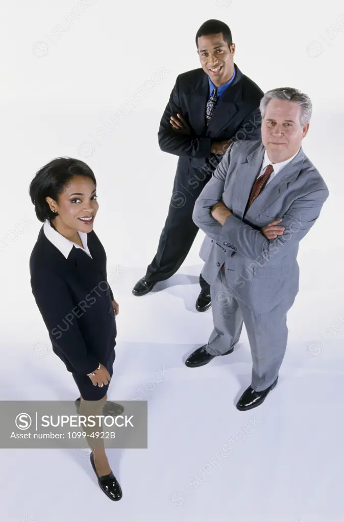 High angle view of a businesswoman and two businessmen smiling