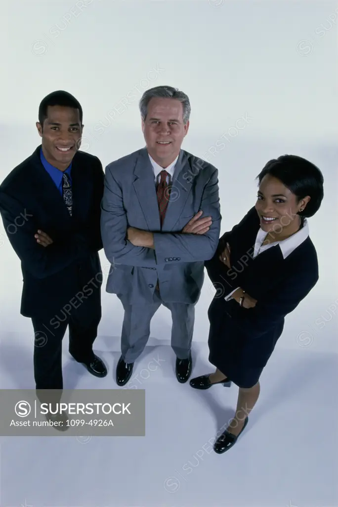 High angle view of three business executives standing with arms folded