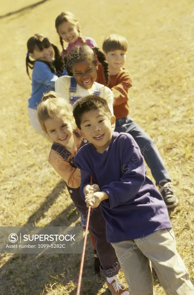 Group of children playing tug-of-war