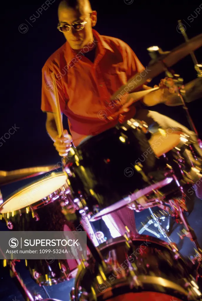Male drummer playing drums
