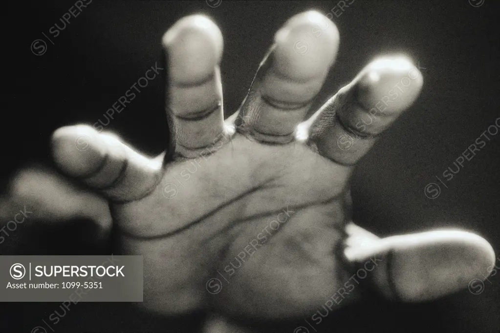 Close-up of a person's hand reaching forward