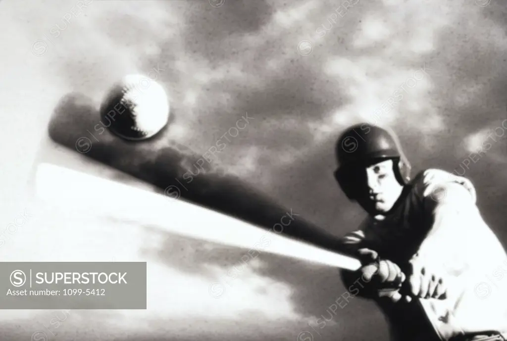 Low angle view of a baseball player swinging a baseball bat