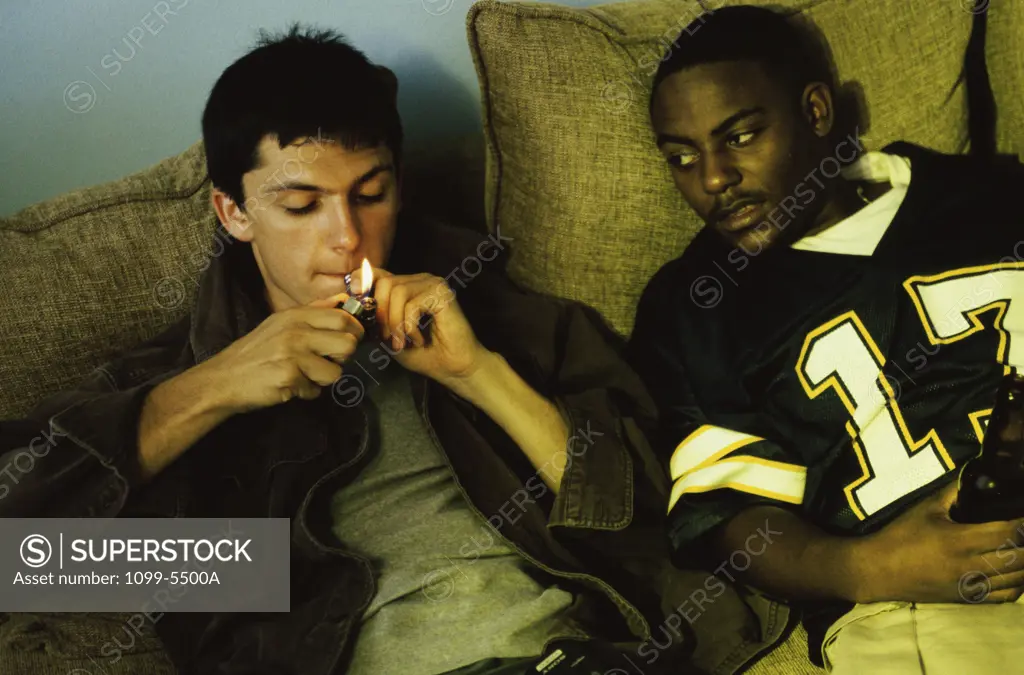 Two teenage boys smoking marijuana