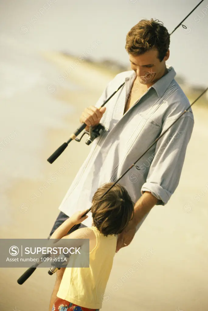 Father and his son holding fishing rods