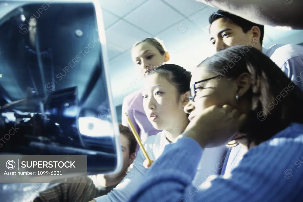 Group of teenagers in front of a computer