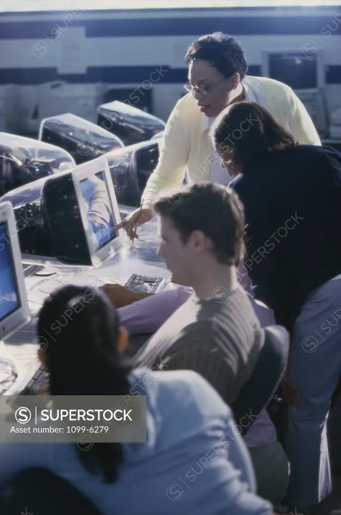Female teacher and her students in a computer class