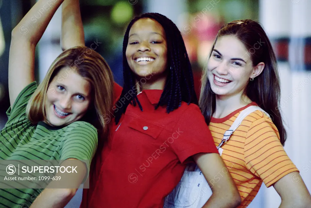 Portrait of three teenage girls smiling
