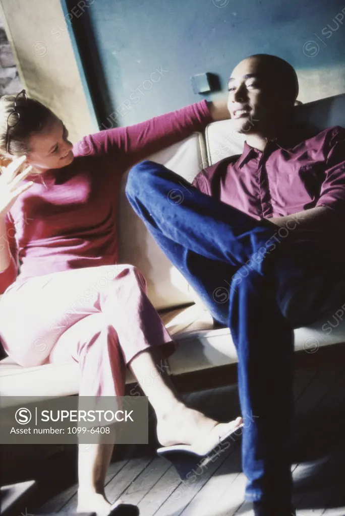 Young couple sitting together on a couch