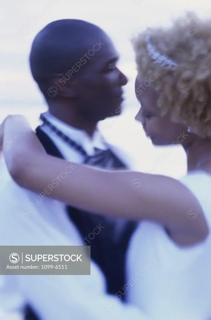 Side profile of a newlywed couple dancing