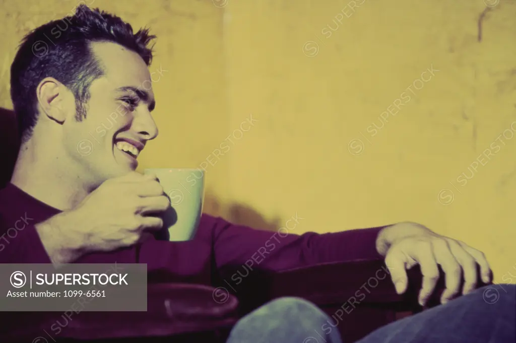 Young man holding a cup of coffee