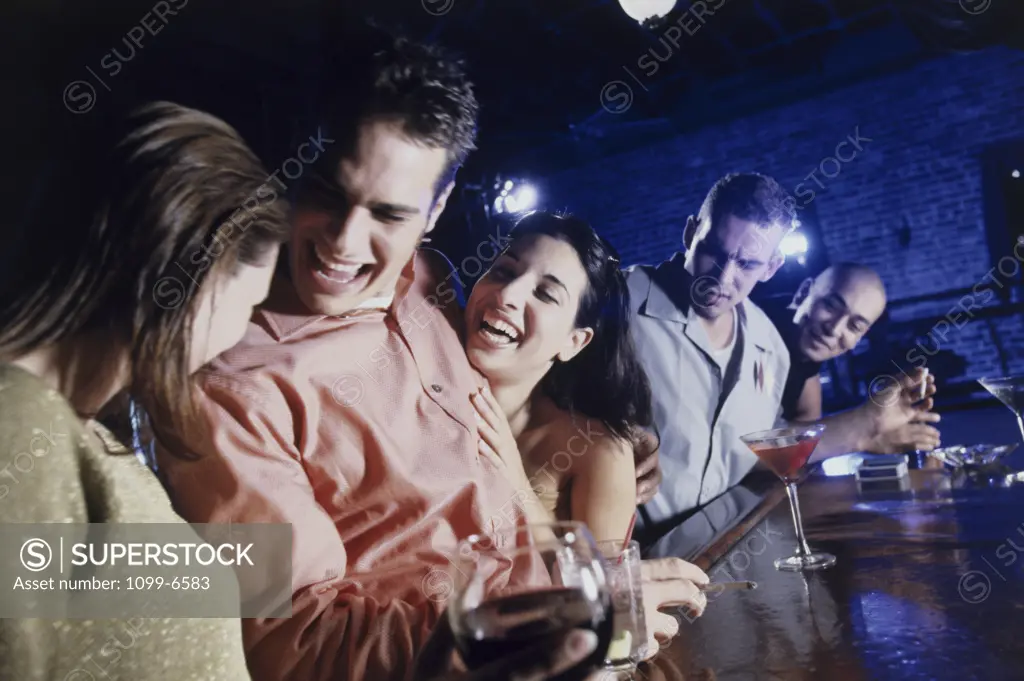 Side profile of a group of young people in a bar