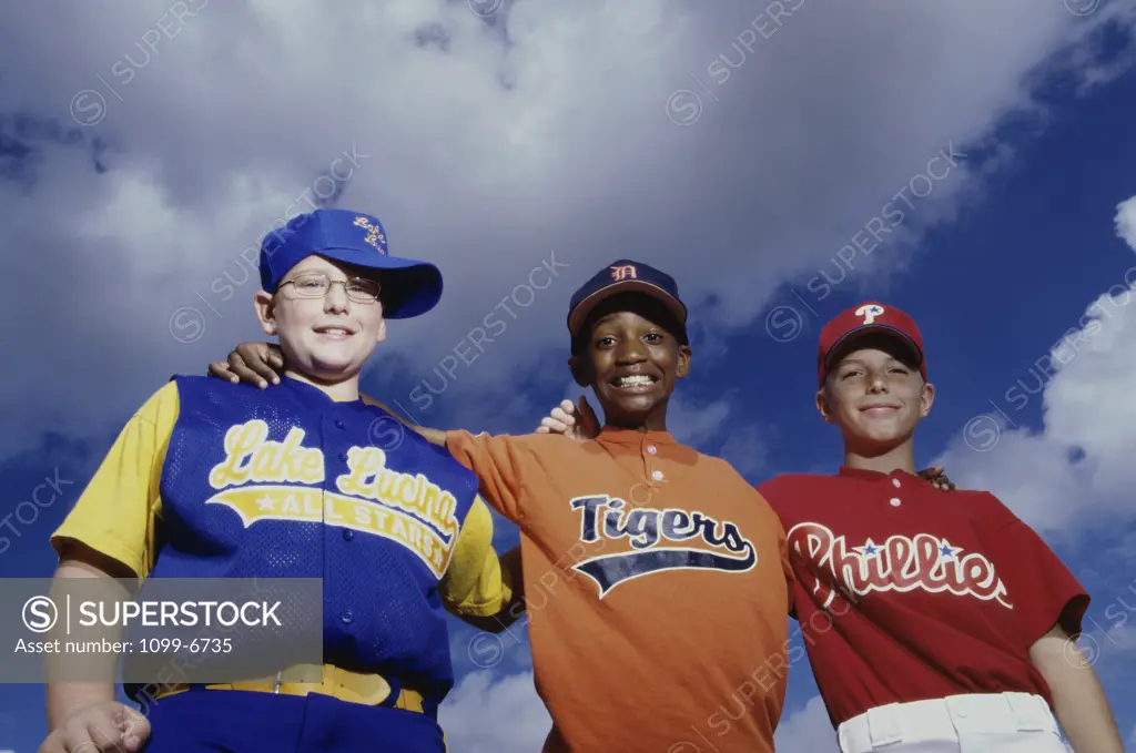 Low angle view of three boys on a baseball team