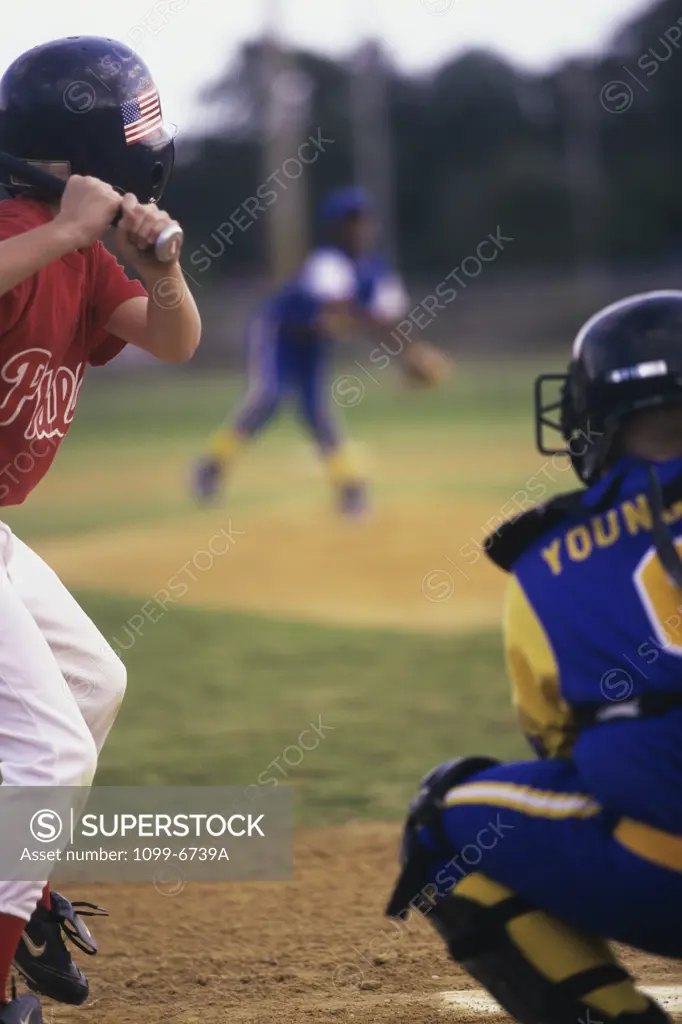 Three boys playing baseball