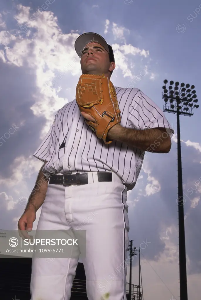 Low angle view of a baseball player holding a baseball mitt