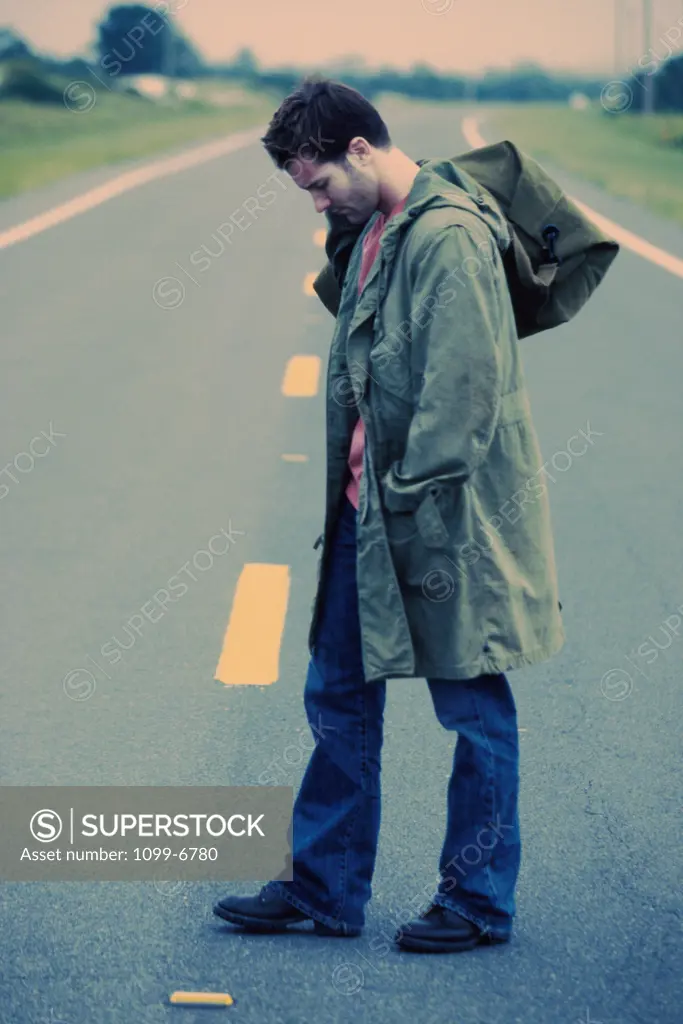 Young man standing in the middle of the road