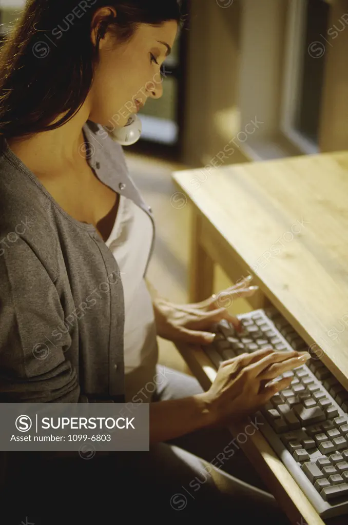 Side profile of a young woman using a computer