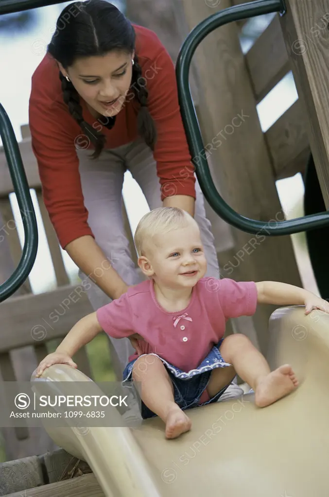 Teenage girl playing with a baby girl