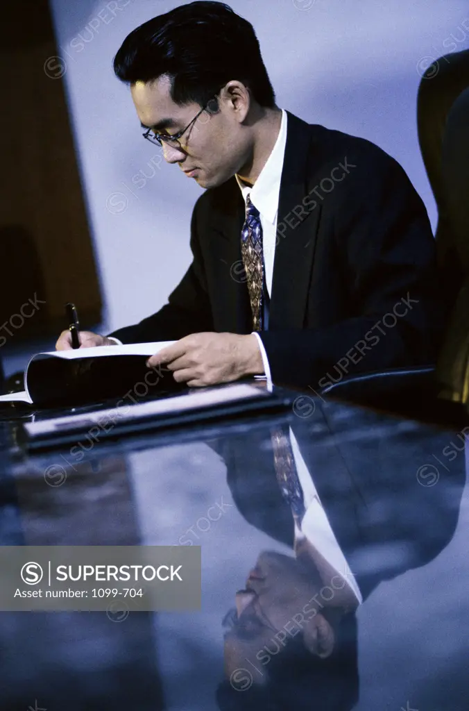 Side profile of a businessman reading a document