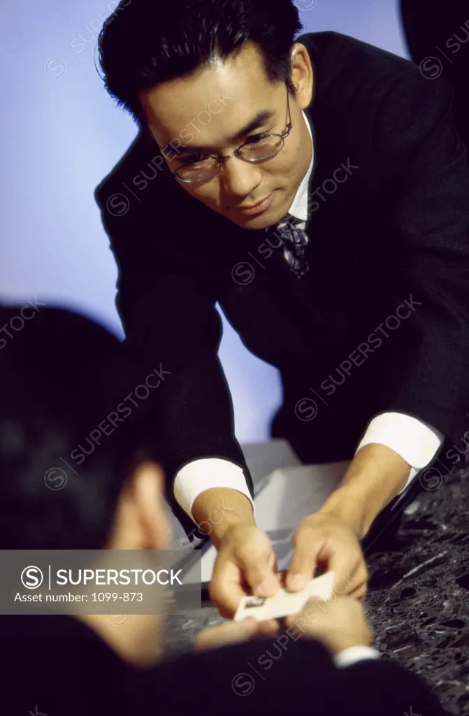 Businessman giving his business card to a businessman