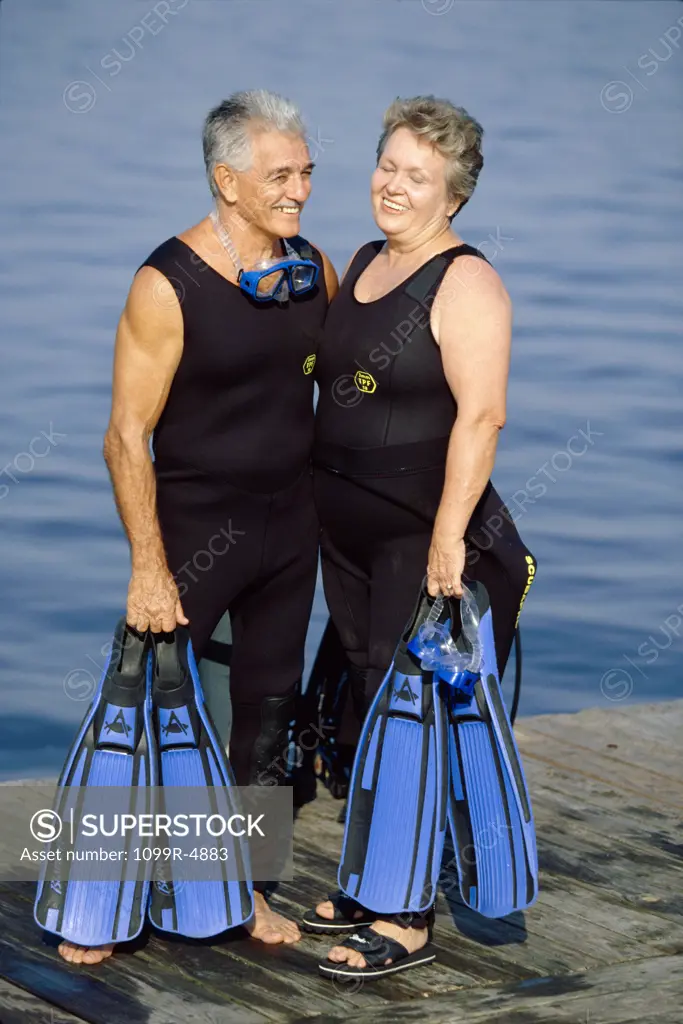 Senior couple standing with scuba gear