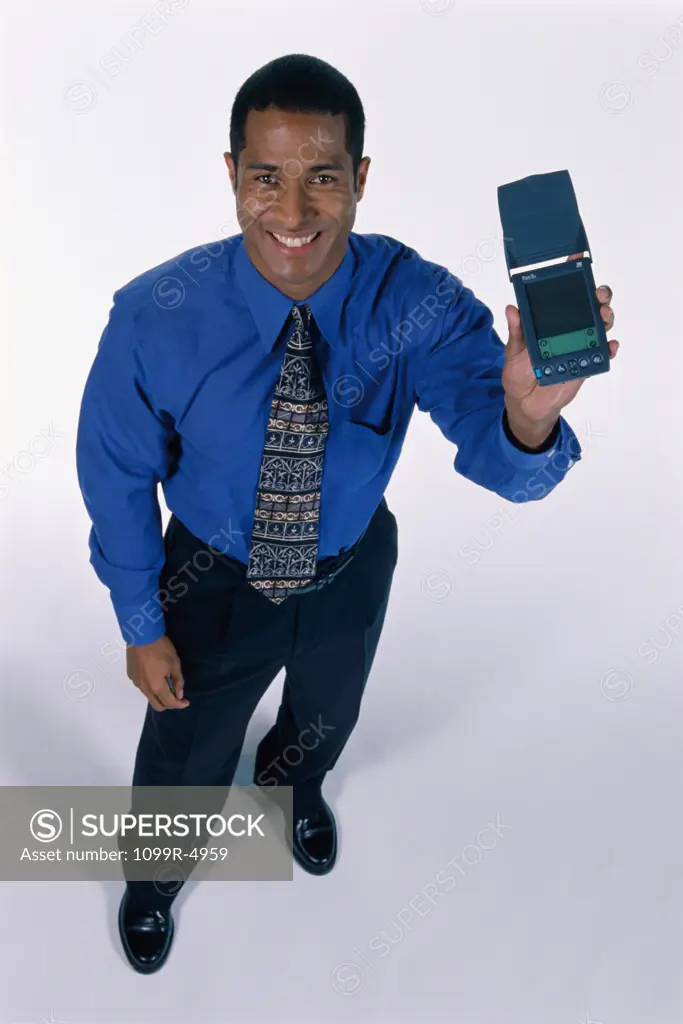 Portrait of a businessman holding a hand held device