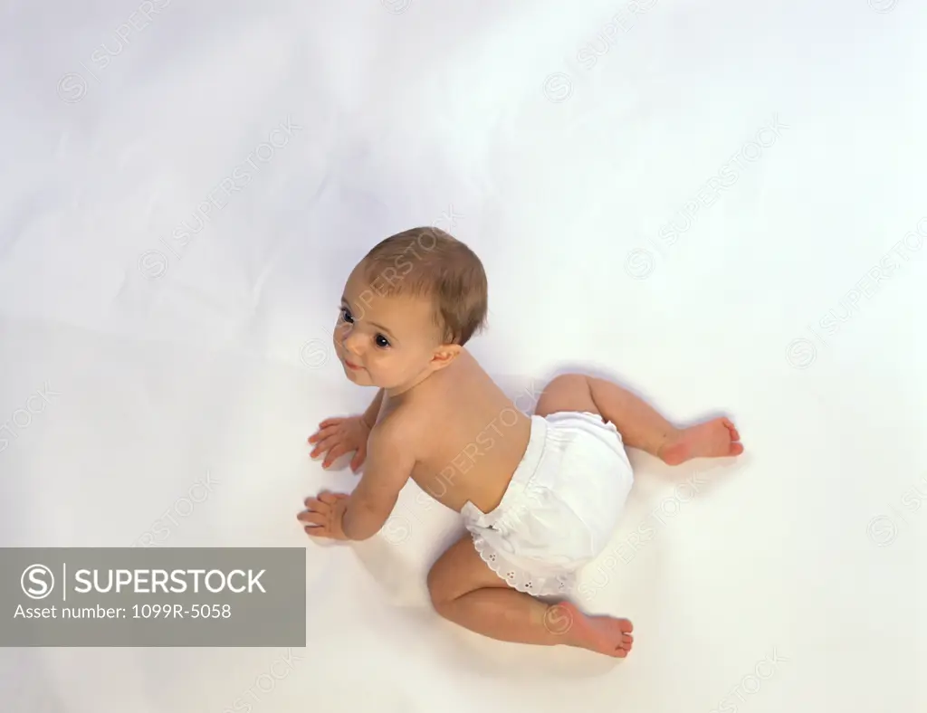 High angle view of a baby crawling on the floor