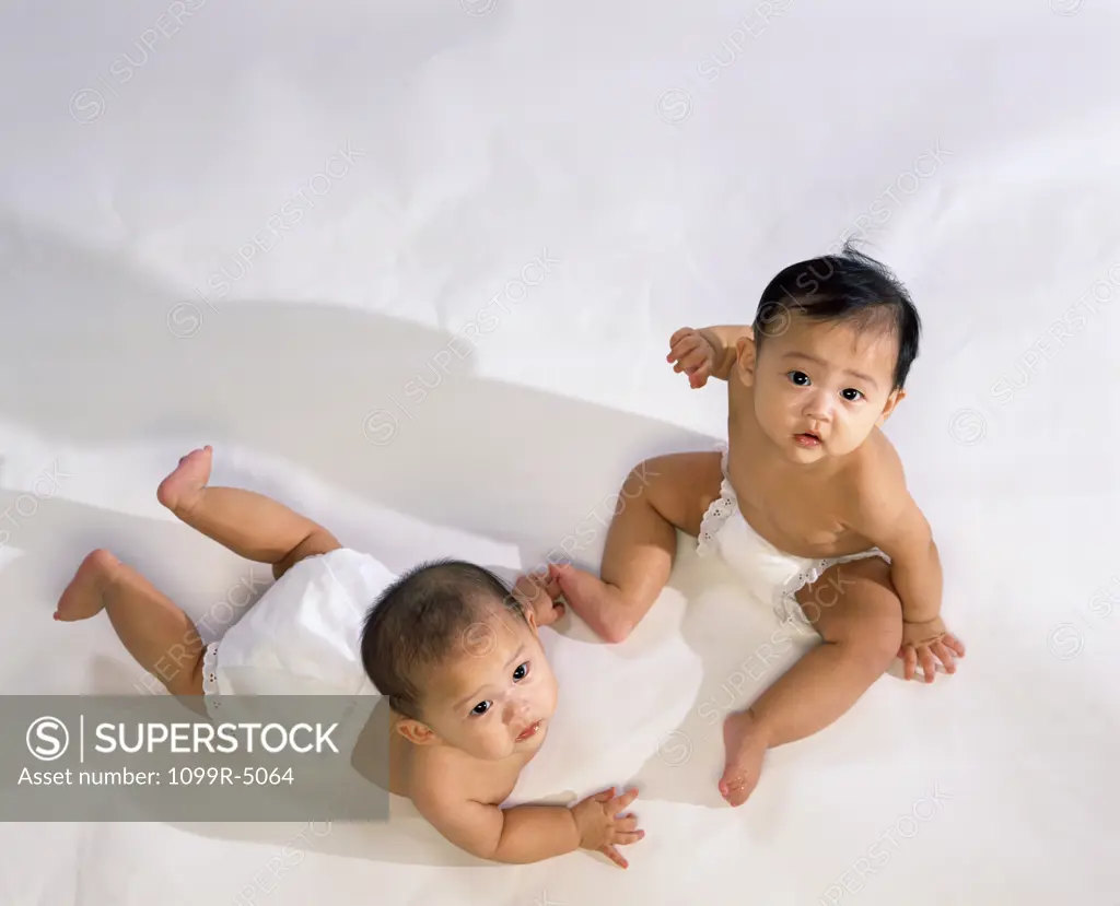 Portrait of two baby boys wearing diapers