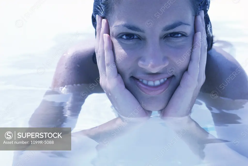 Portrait of a young woman smiling in a swimming pool