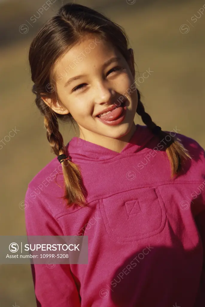 Portrait of a girl sticking out her tongue