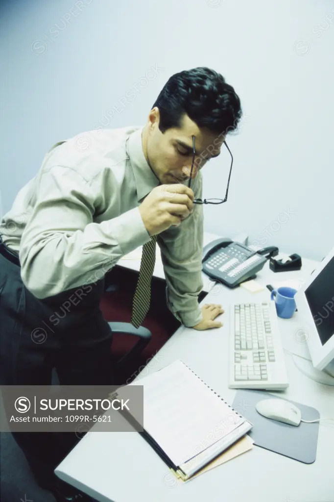 Businessman standing behind an office desk