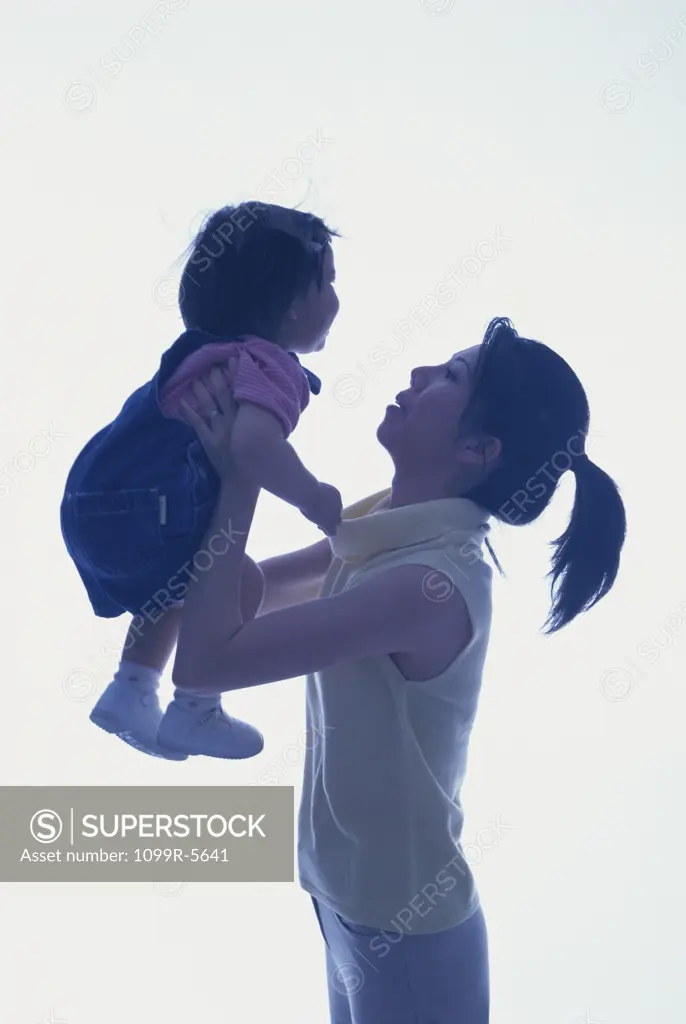 Side profile of a mother holding her baby girl