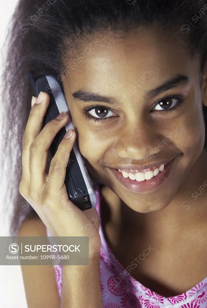 Portrait of a teenage girl talking on a mobile phone