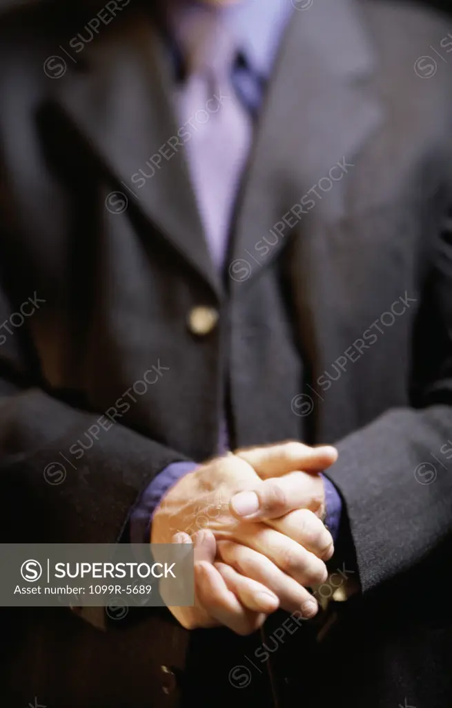 Close-up of a businessman with his hands together