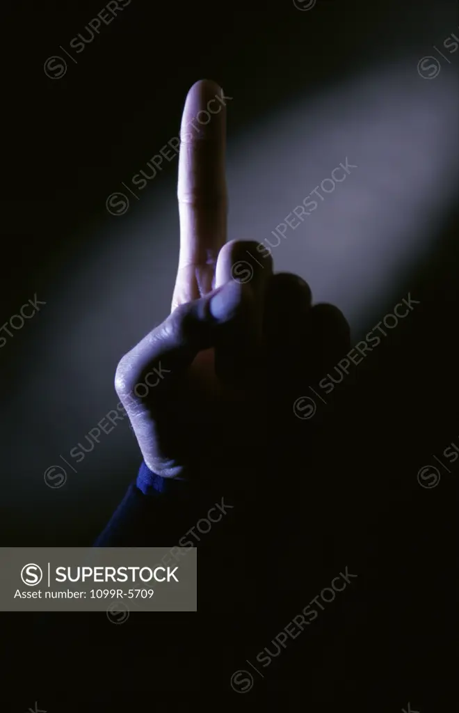 Close-up of a person's finger pointing up
