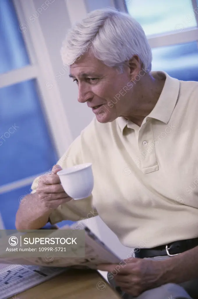 Elderly man holding a teacup
