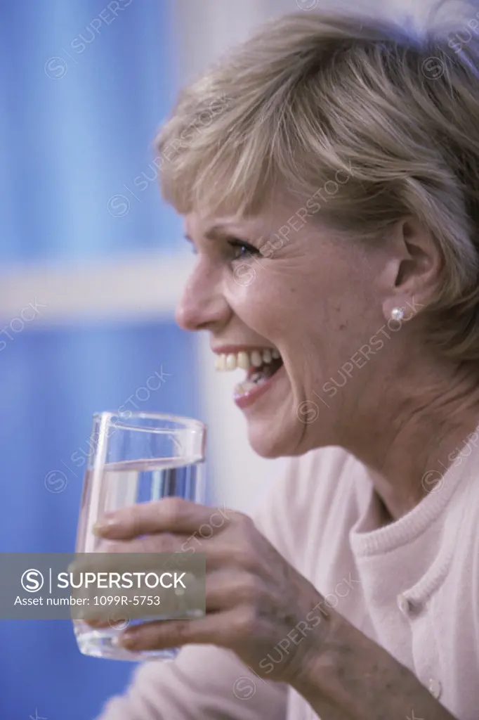 Elderly woman holding a glass of water