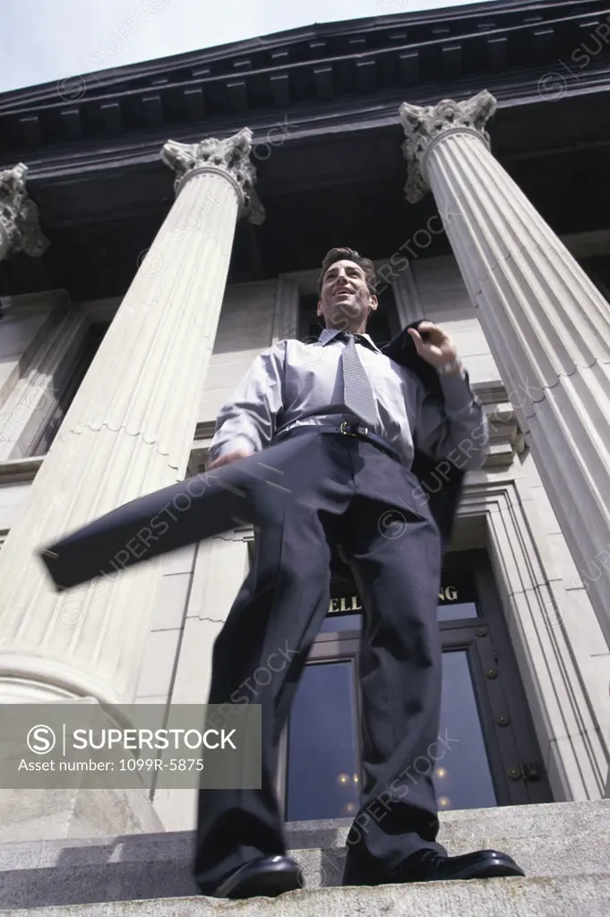 Low angle view of a businessman standing on stairs