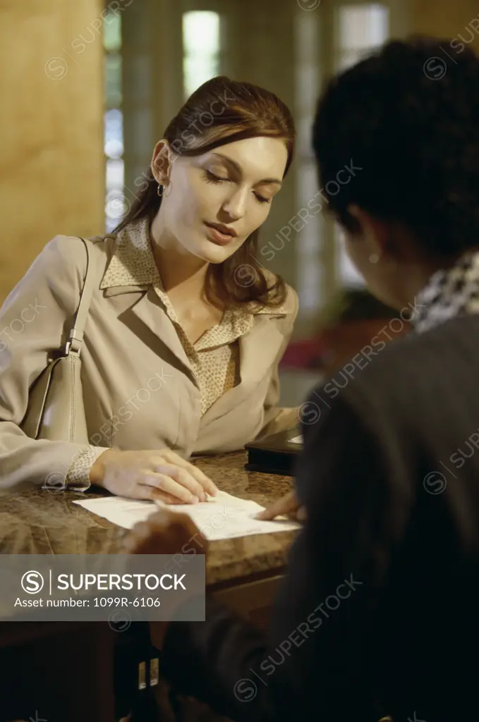 Businesswoman paying a hotel bill