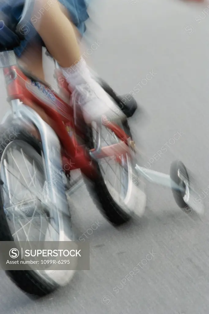 Low section view of a girl riding a bicycle
