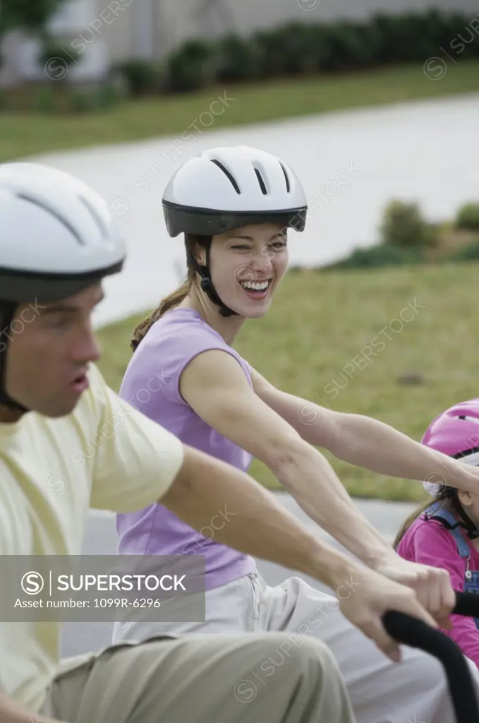Side profile of a young couple cycling