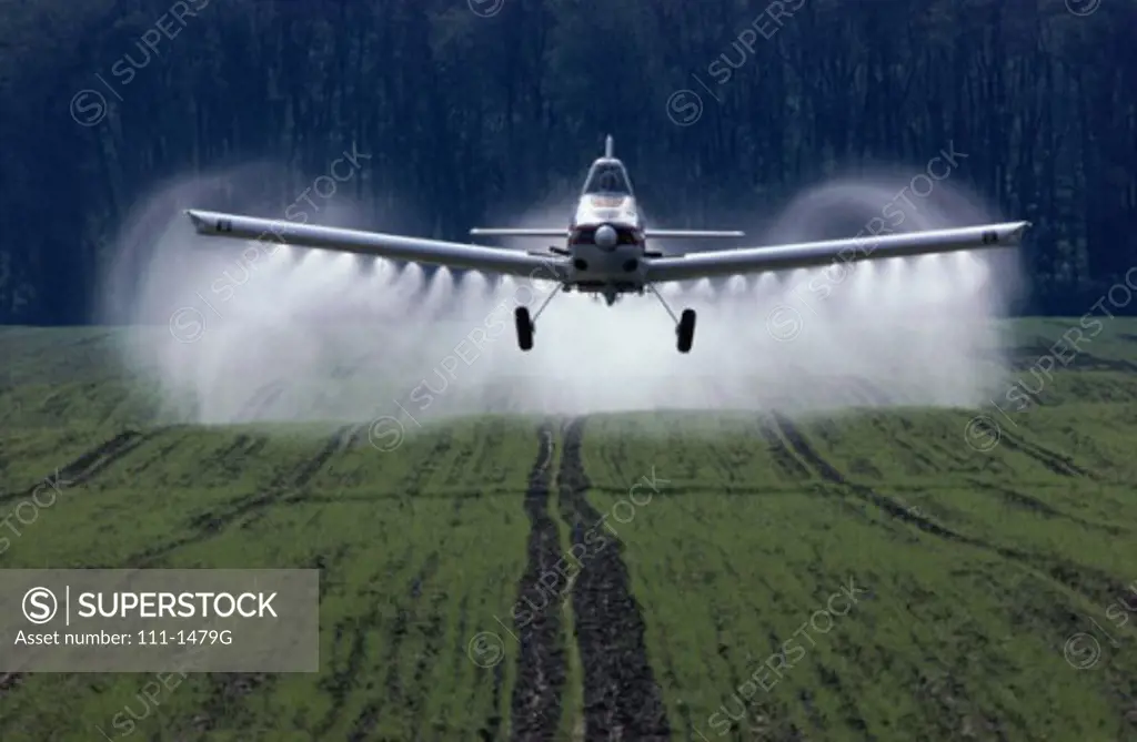 Airplane spraying over a field