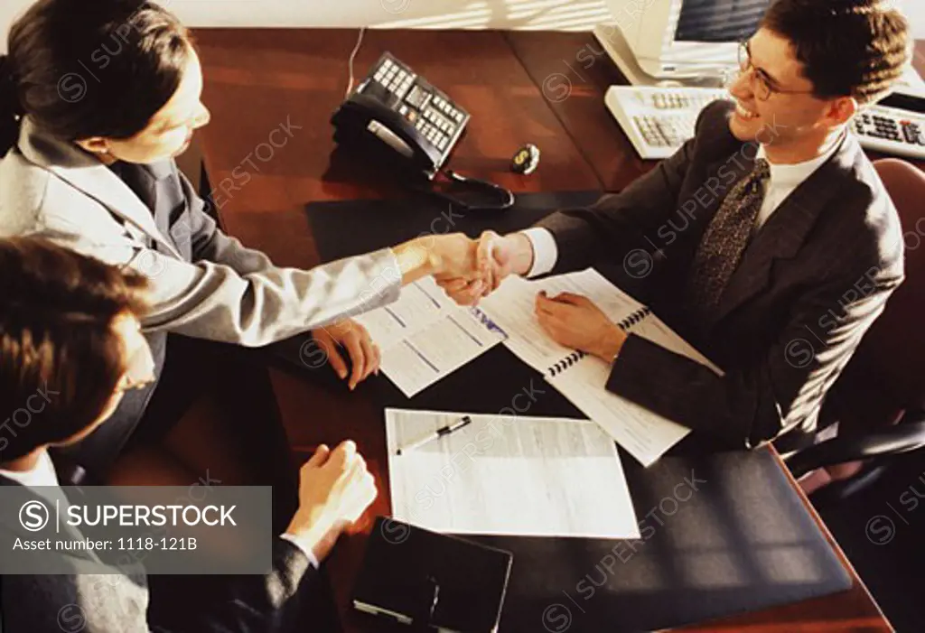 High angle view of a businesswoman shaking hands with a businessman